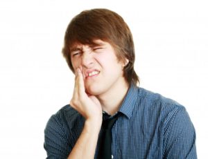 Young man having pain in teeth