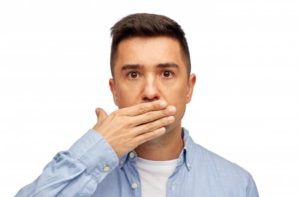 Man hiding his teeth