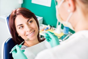 Smiling woman at dentist sitting in dentist chair