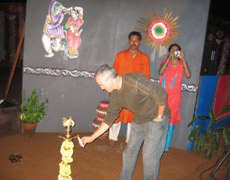 Dr. Arnold lights the flame of knowledge at a party in his group’s honor in Bangalore